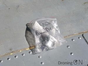 Photo from ar15.com showing the arm of the Phantom drone in an evidence bag.